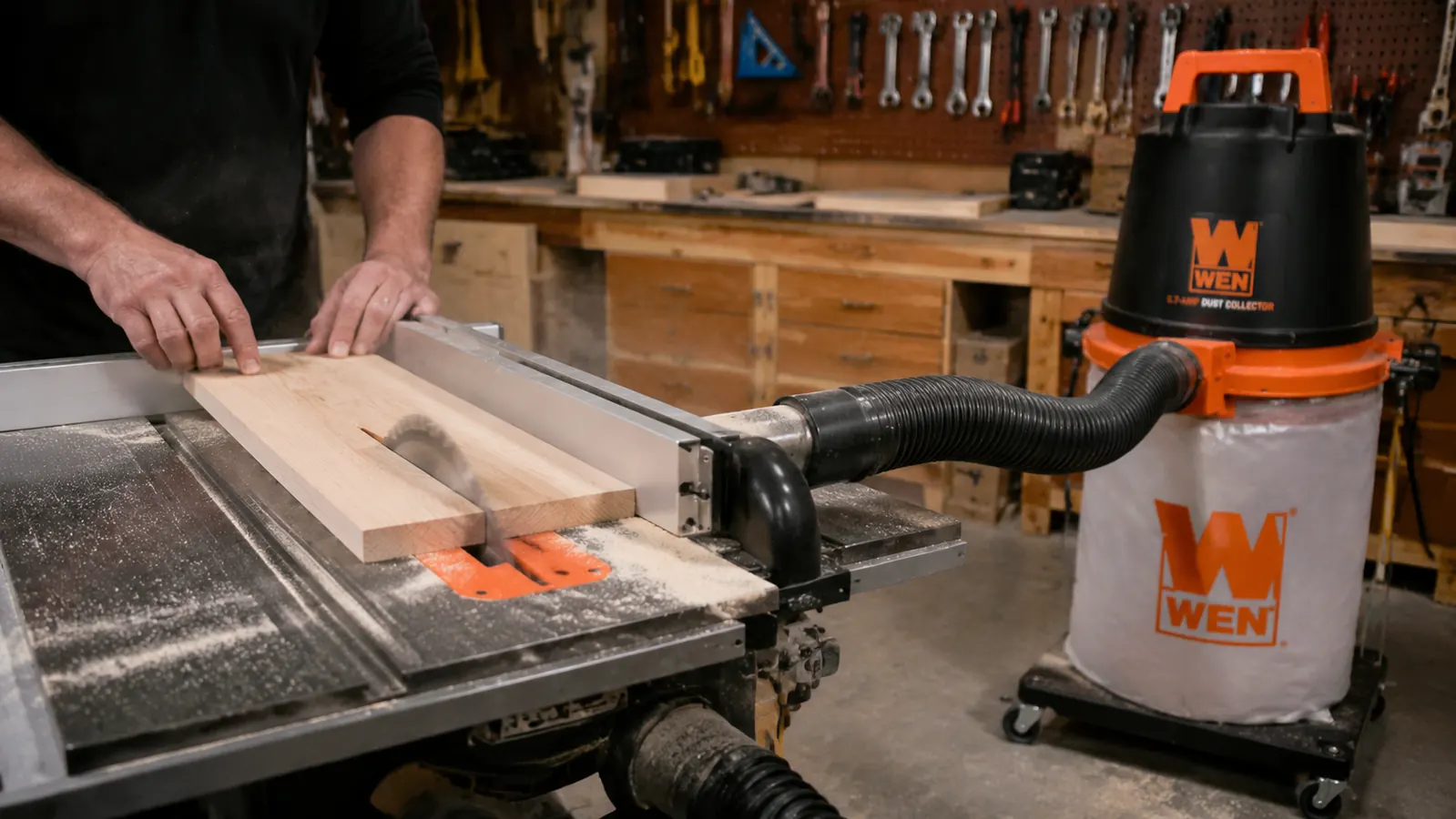WEN dust collector connected by 4-inch hose to a table saw, 12-gallon bag inflated, sawdust being pulled away from the blade