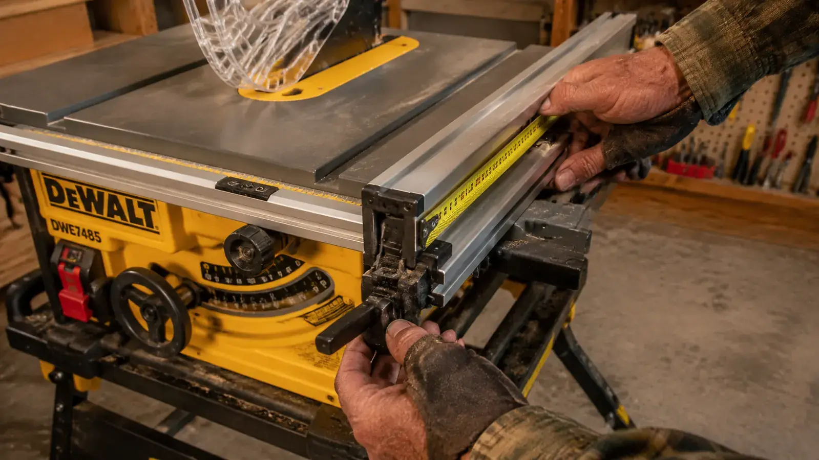 Close-up of a table saw fence being set and locked against a tape measure mark on the rail