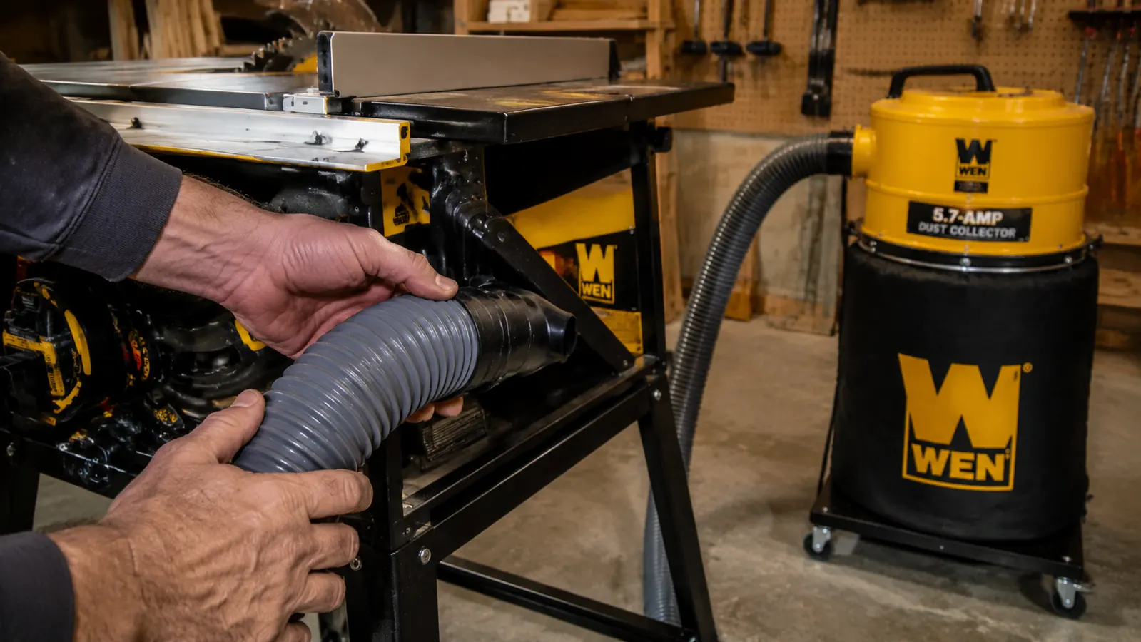 Man connecting a 4-inch dust hose from a WEN dust collector to a table saw dust port