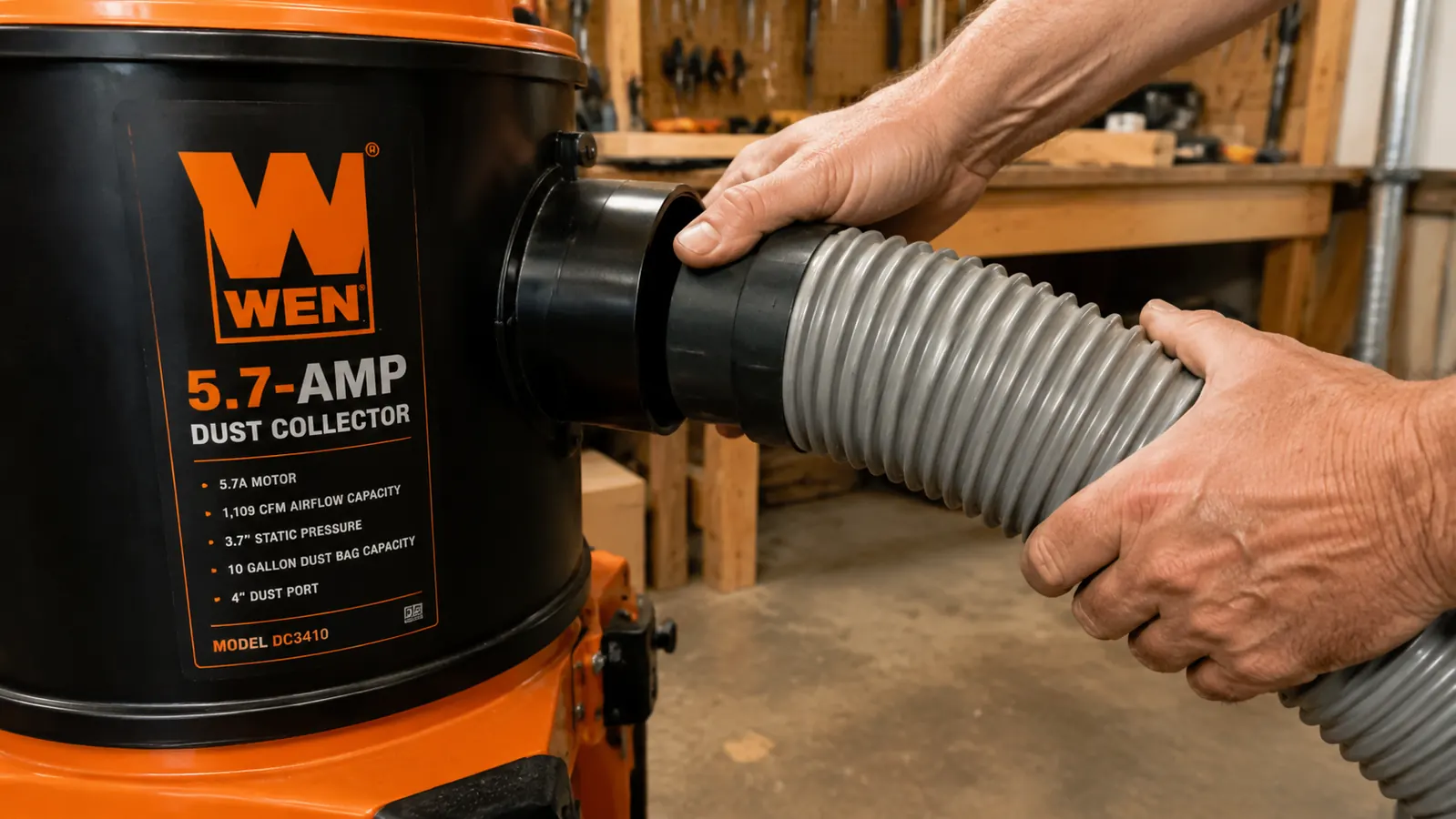 Hand connecting a 4-inch dust collection hose to the WEN dust collector inlet port